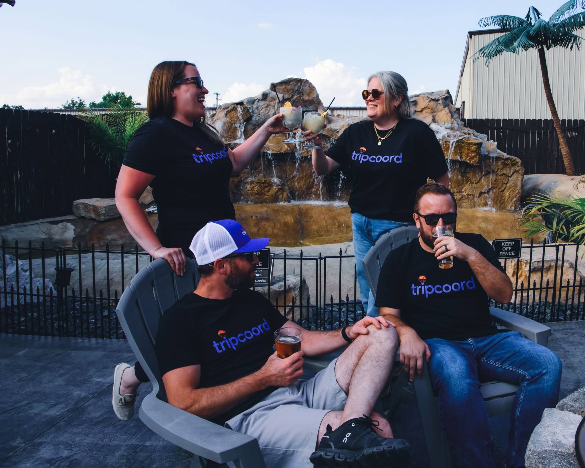 Abby, Brandon, Mallory and Luke in tripcoord shirts, drinks in hand
