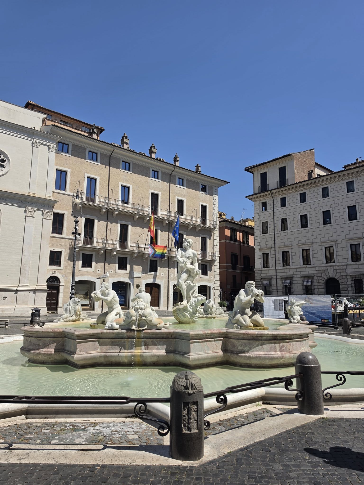 A marble fountain in a historic European plaza